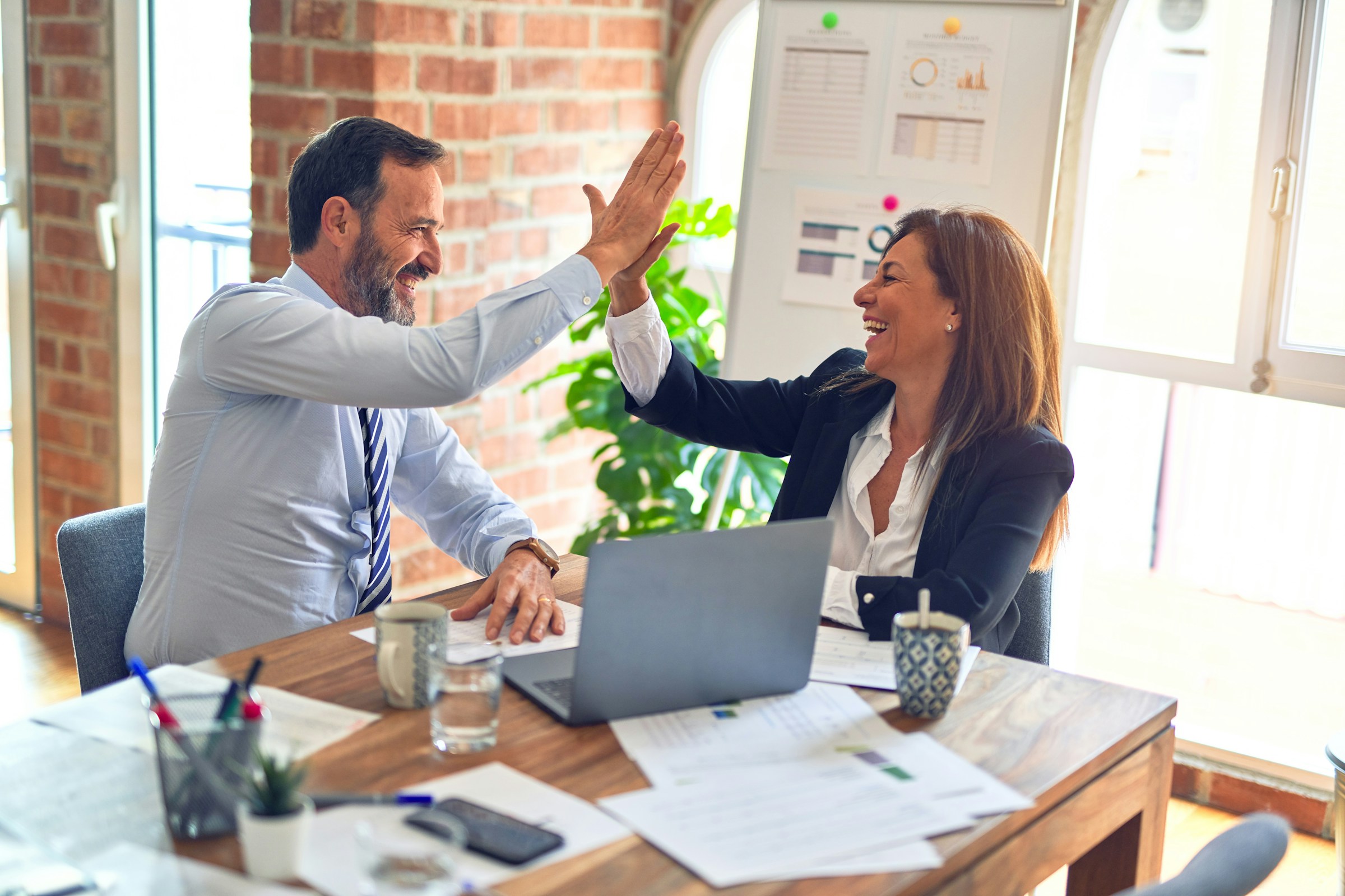 People High fiving in Office - Omnichannel CRM