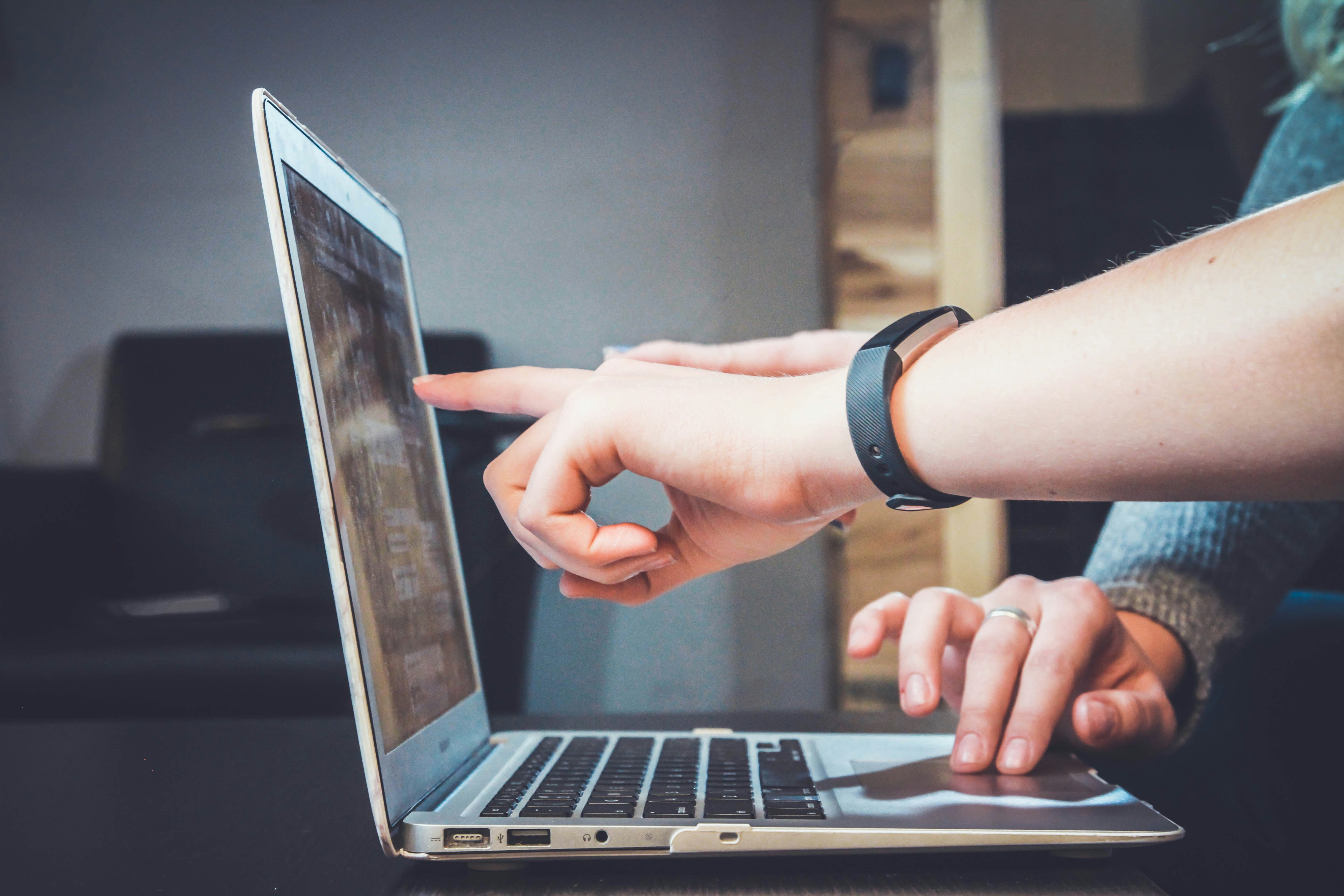 Person Pointing at a Laptop - Omnichannel Marketing Strategy