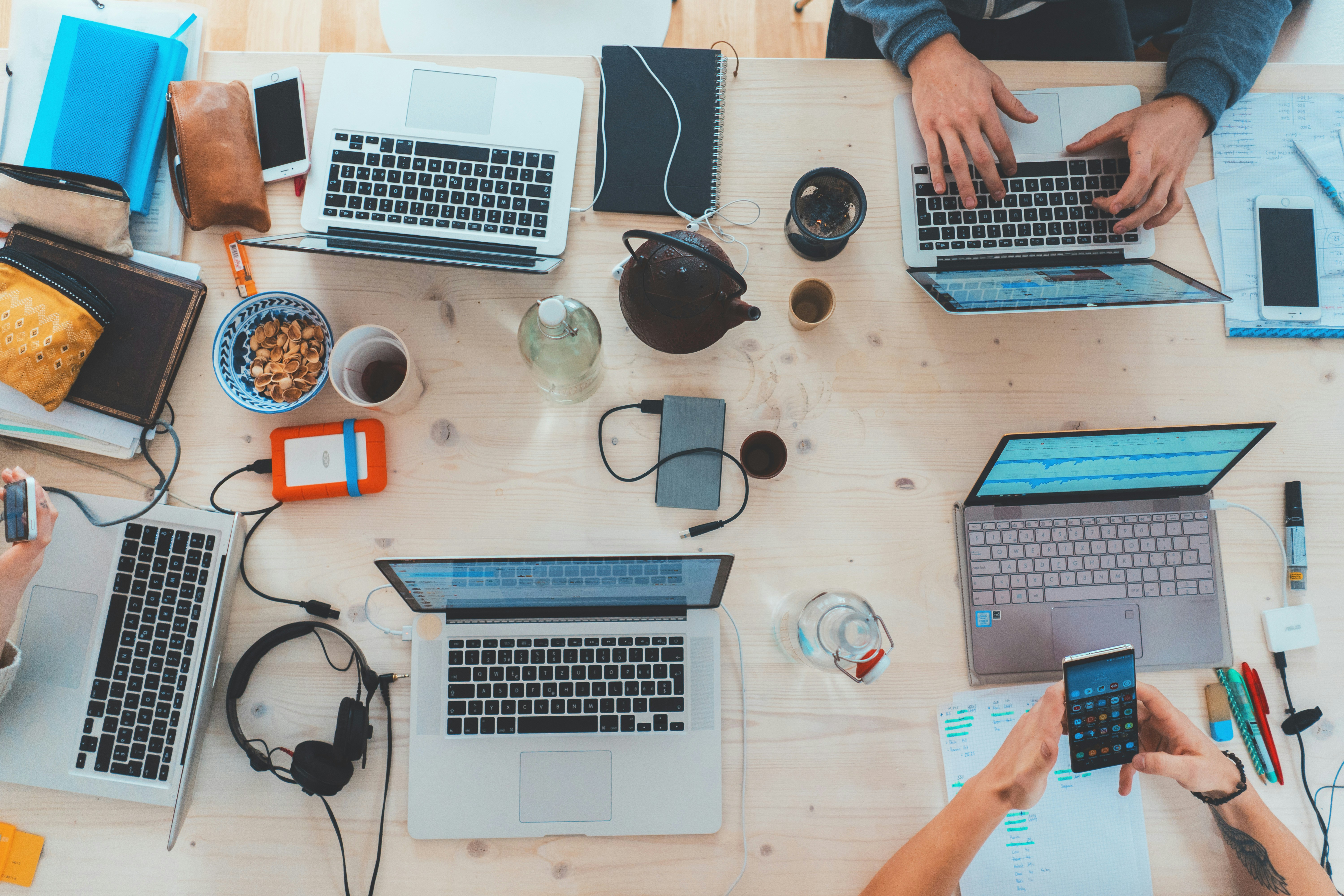 Persons Using Laptop in a Meeting - Omnichannel Marketing Strategy