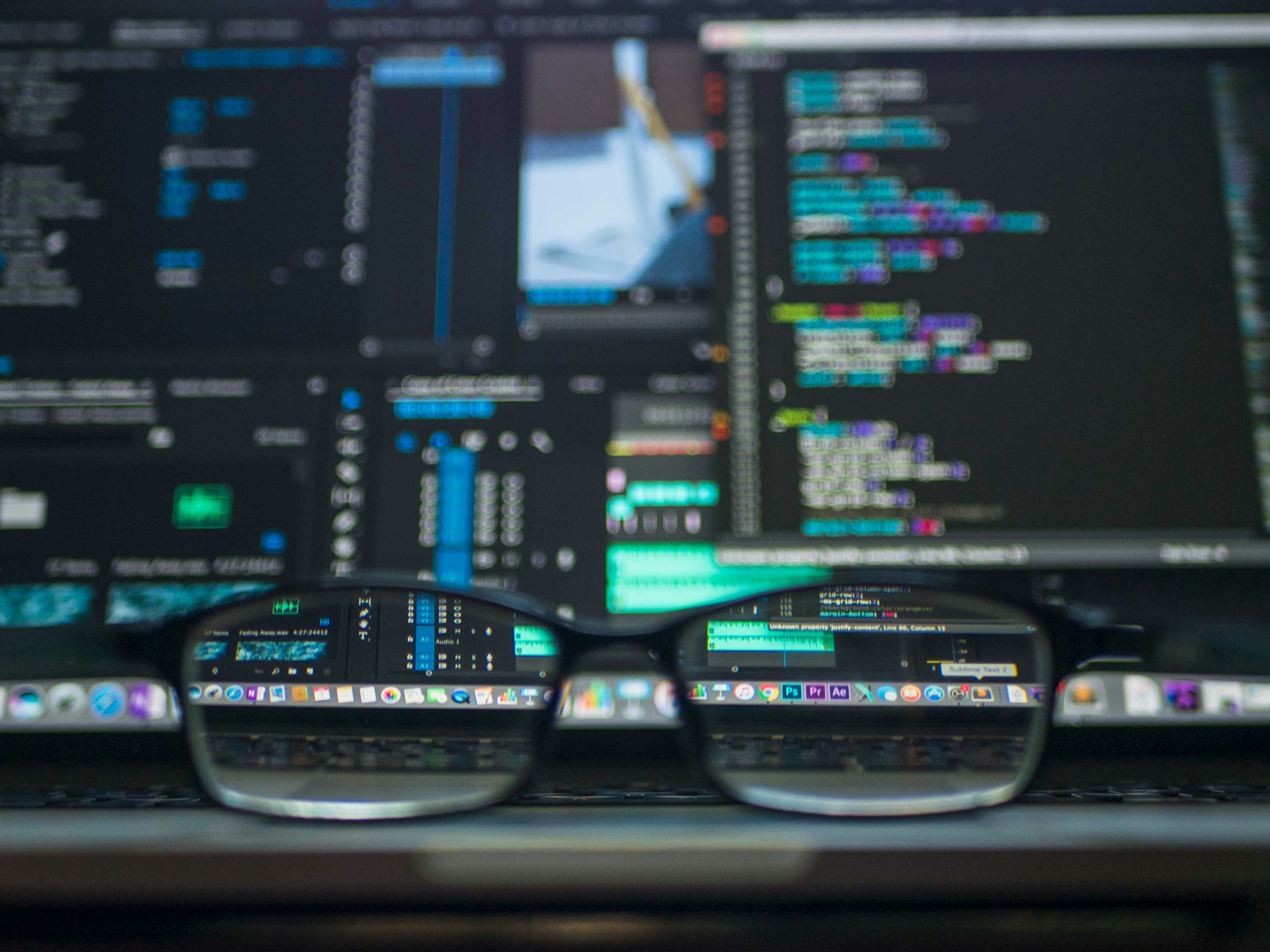 Glasses Placed on Computer Table - Customer Data Platform Vs Marketing Automation